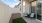 private yard with grass and two chairs